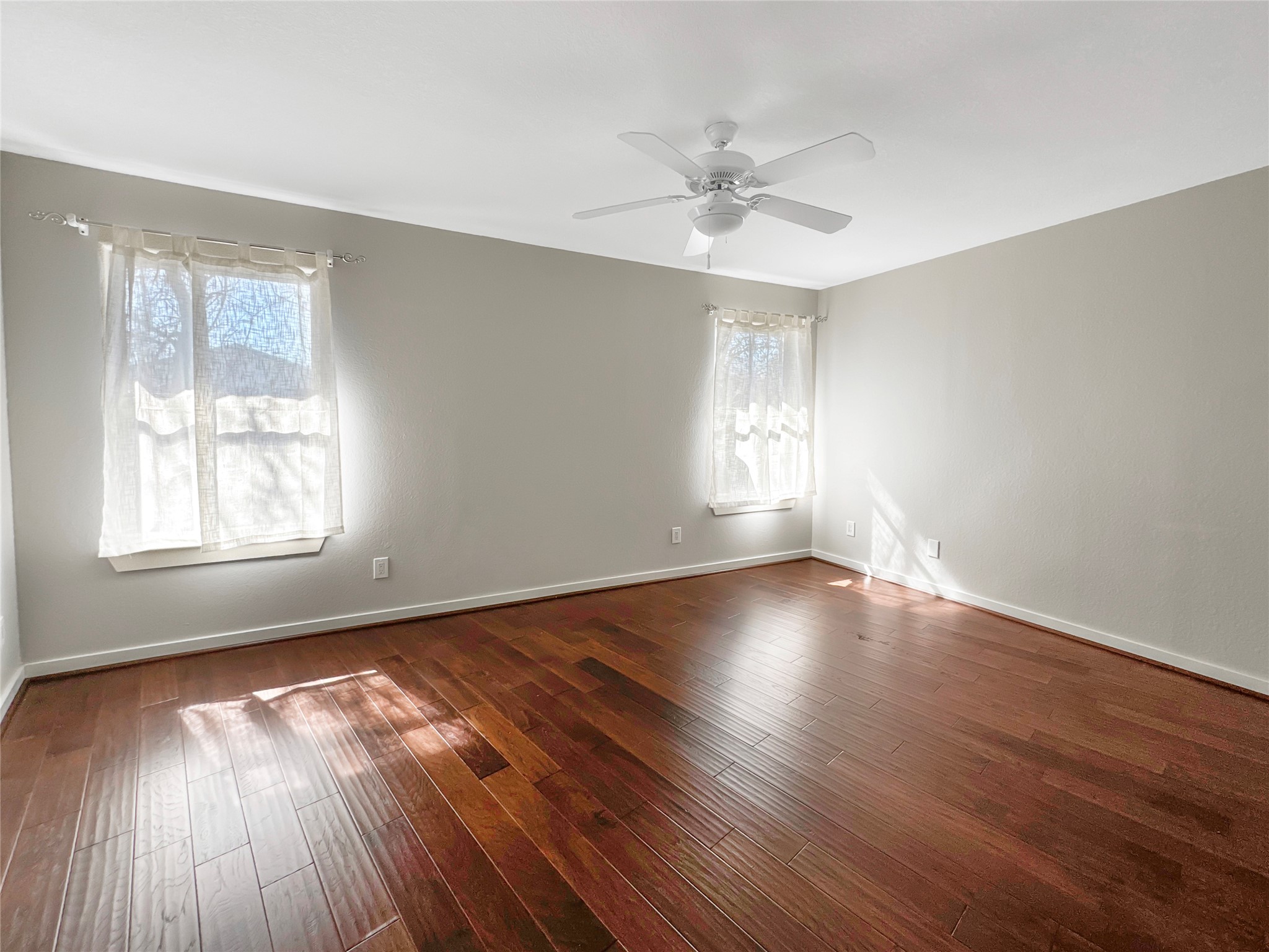 2114 Goodrich Avenue, Unit 4 Austin, TX 78704 - Photo 14 of 24 a view of an empty room with wooden floor and a window