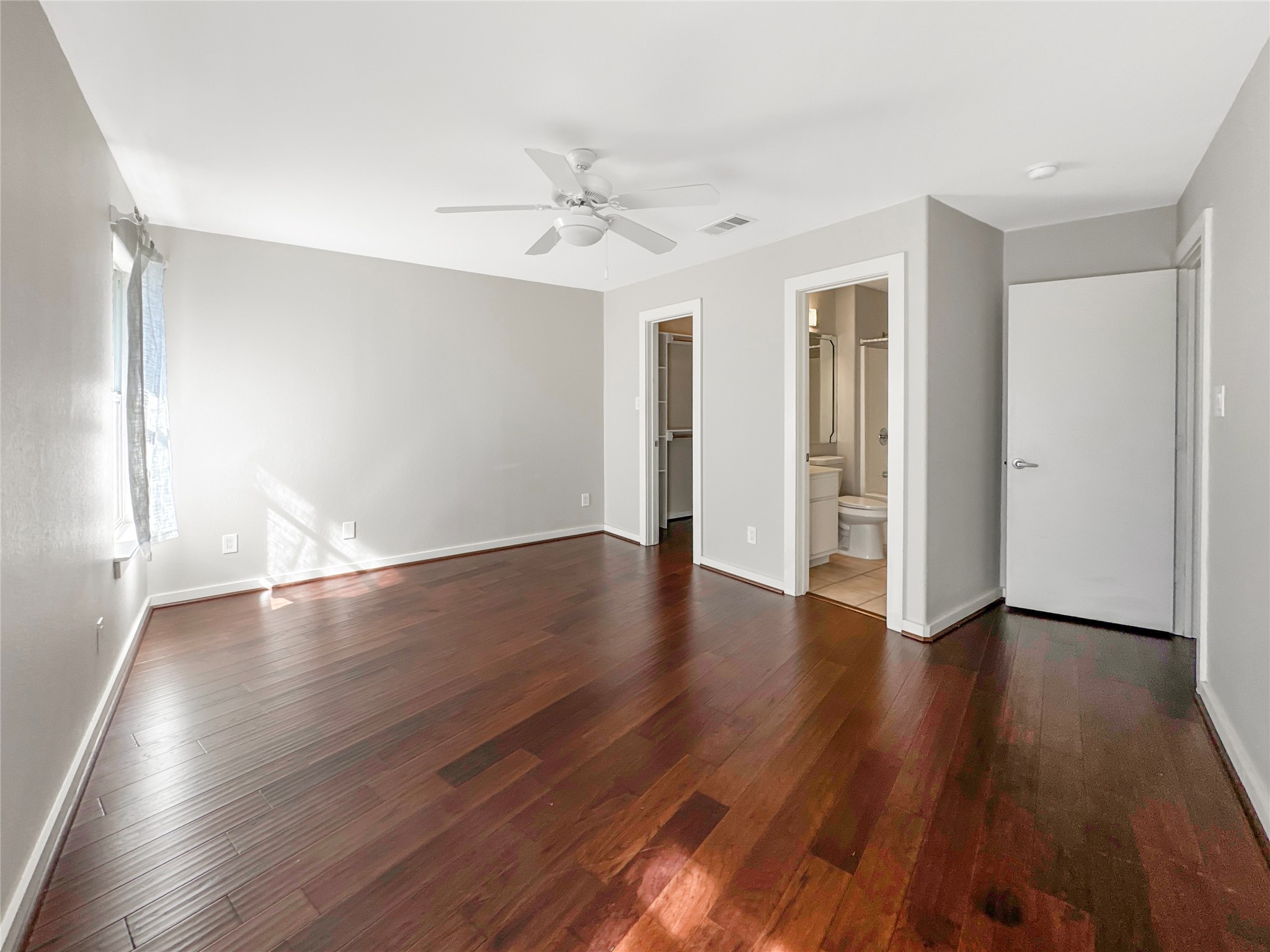 2114 Goodrich Avenue, Unit 4 Austin, TX 78704 - Photo 15 of 24 a view of an empty room with wooden floor and window
