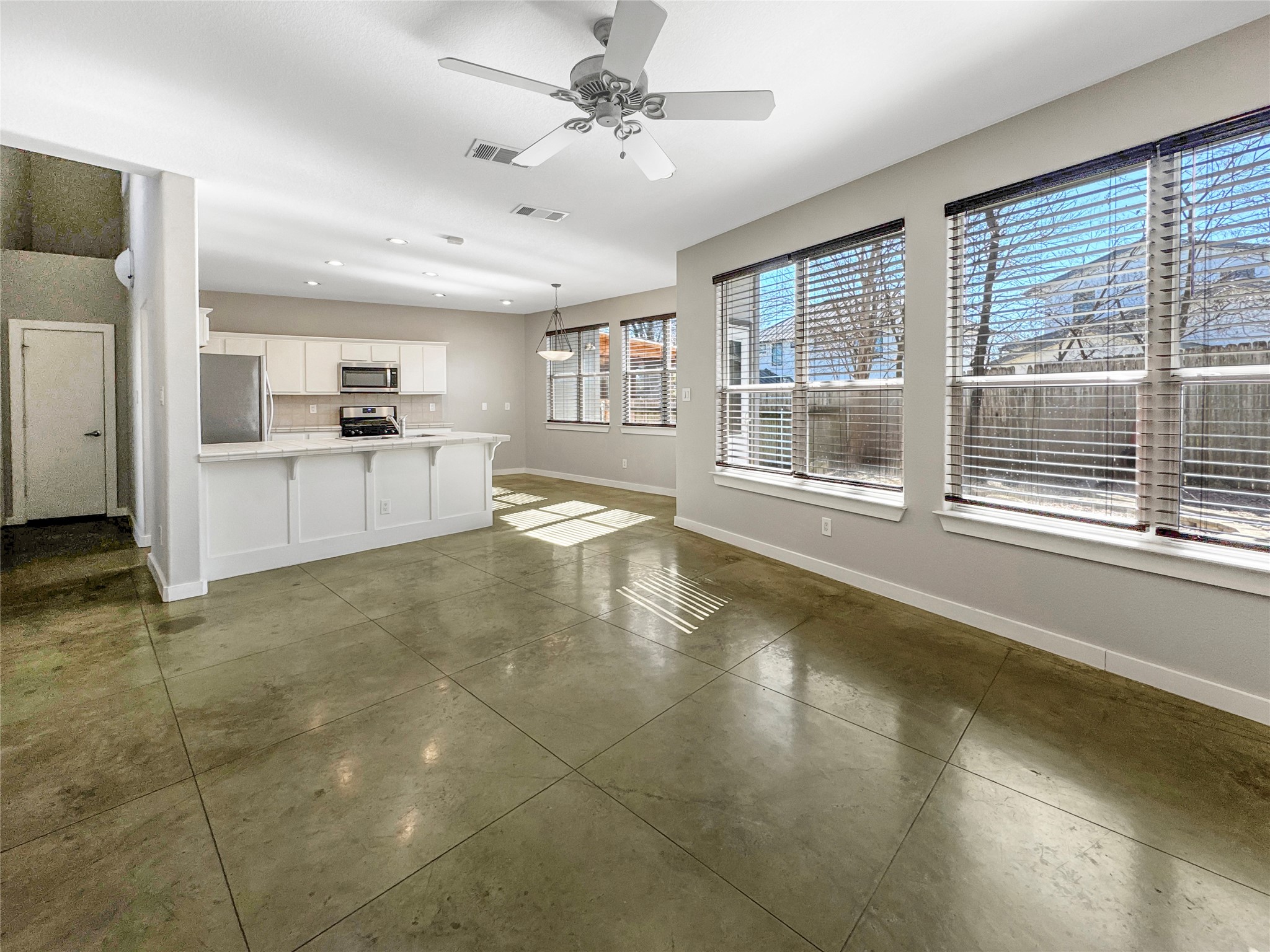 2114 Goodrich Avenue, Unit 4 Austin, TX 78704 - Photo 6 of 24 a large white kitchen with granite countertop a large window and a counter space