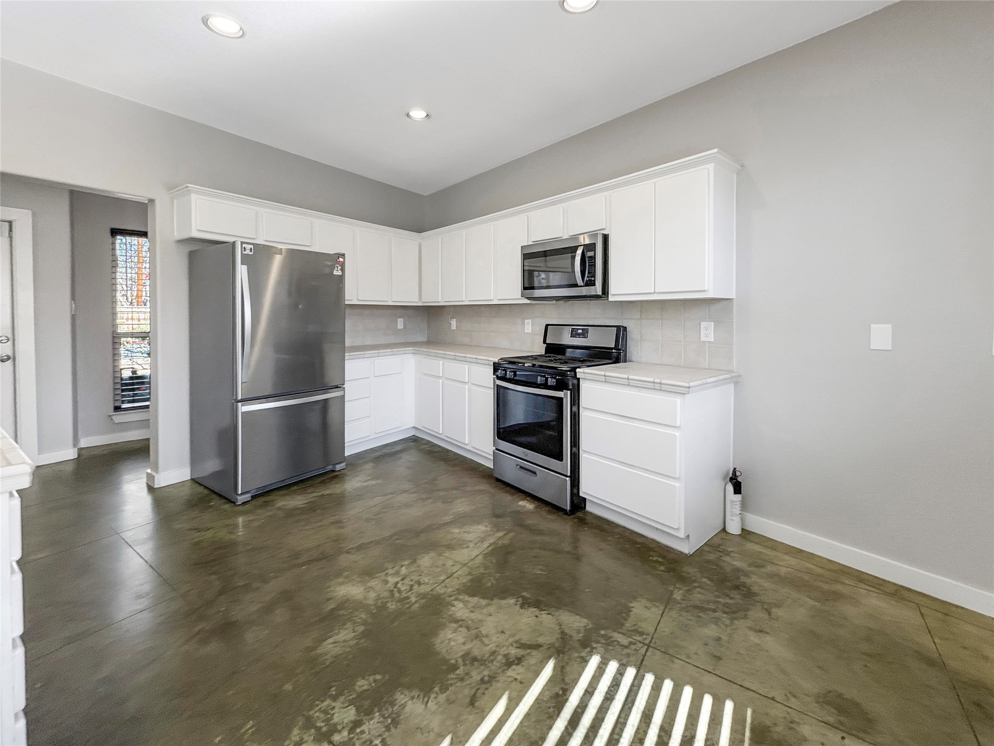 2114 Goodrich Avenue, Unit 4 Austin, TX 78704 - Photo 8 of 24 a kitchen with stainless steel appliances a refrigerator sink and stove
