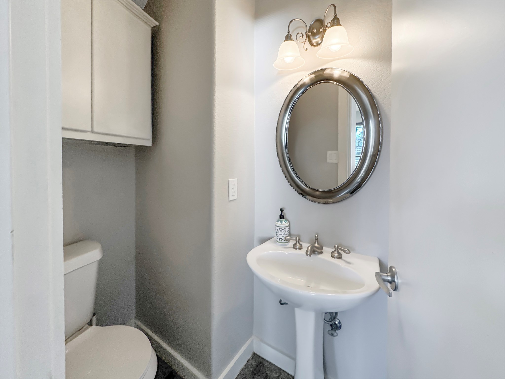 2114 Goodrich Avenue, Unit 4 Austin, TX 78704 - Photo 9 of 24 a bathroom with a toilet sink and mirror