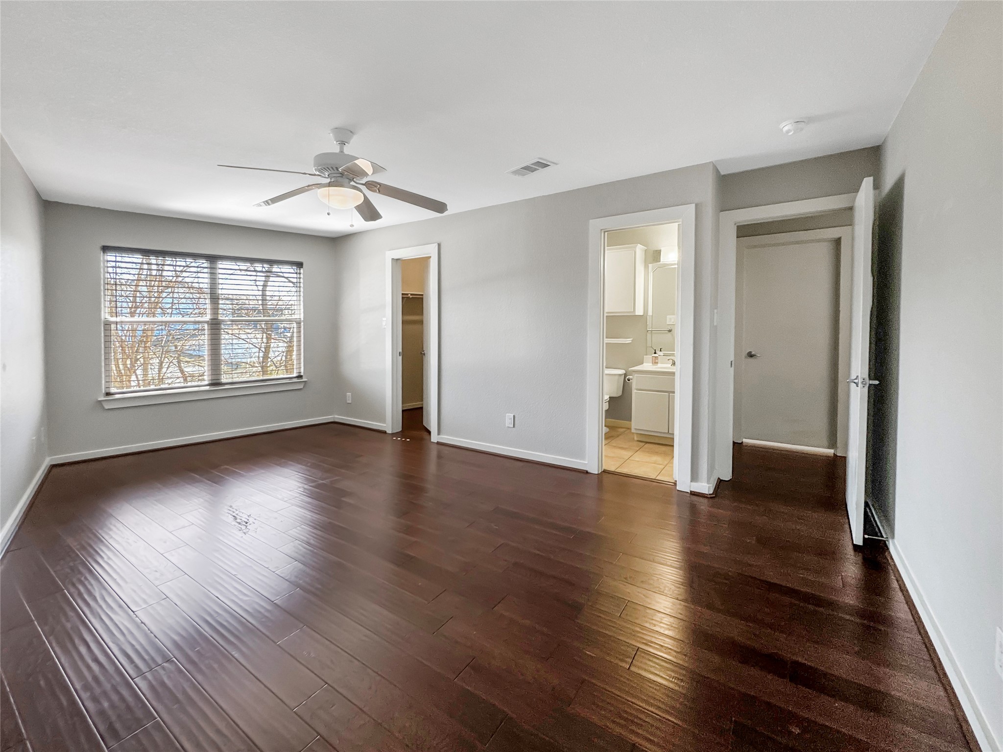 2114 Goodrich Avenue, Unit 4 Austin, TX 78704 - Photo 10 of 24 an empty room with wooden floor and windows