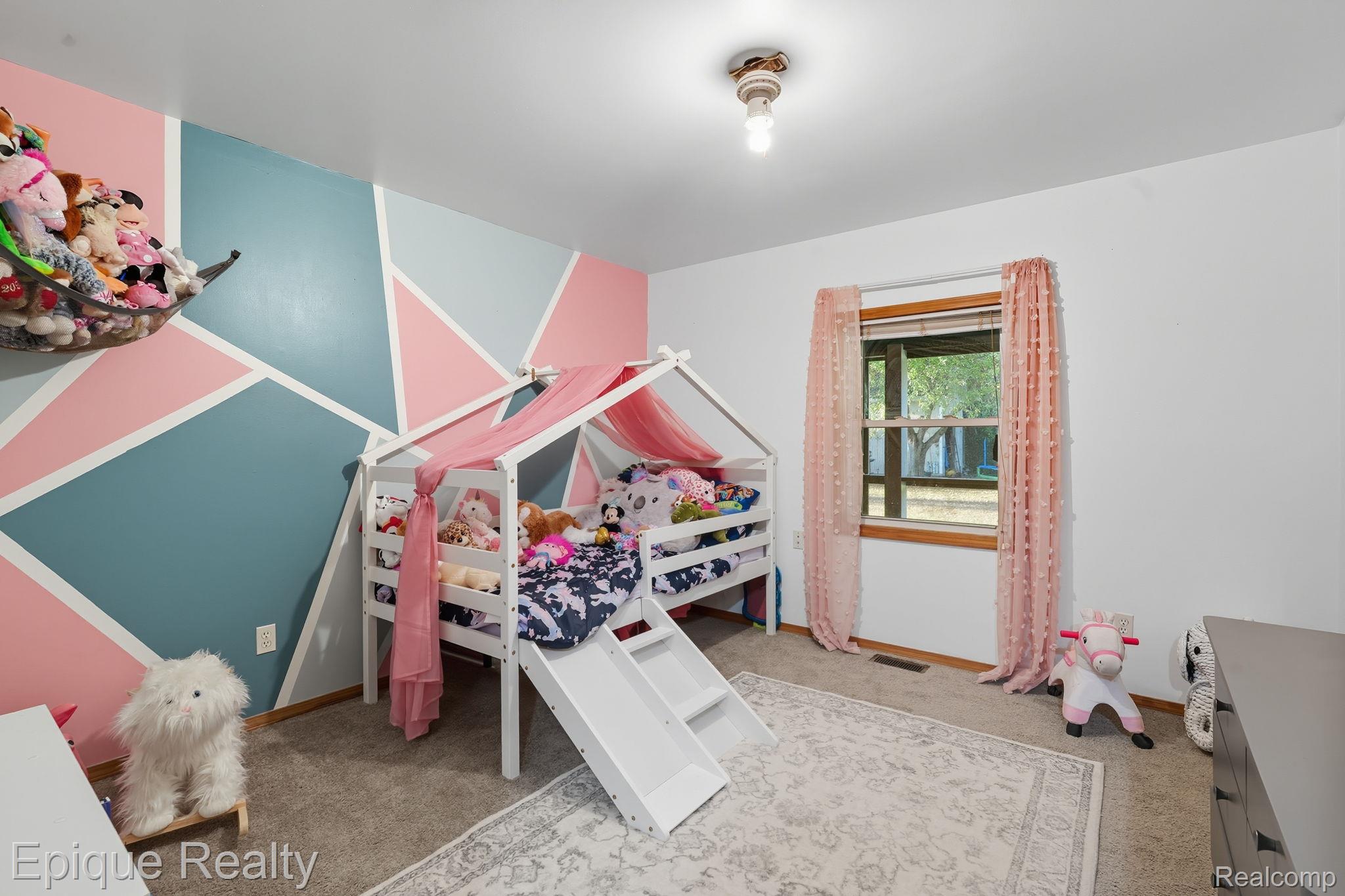 8150 Runyan Lake Road Fenton, MI 48430 - Photo 20 of 41 Second first floor bedroom featuring light carpet and ceiling fan.