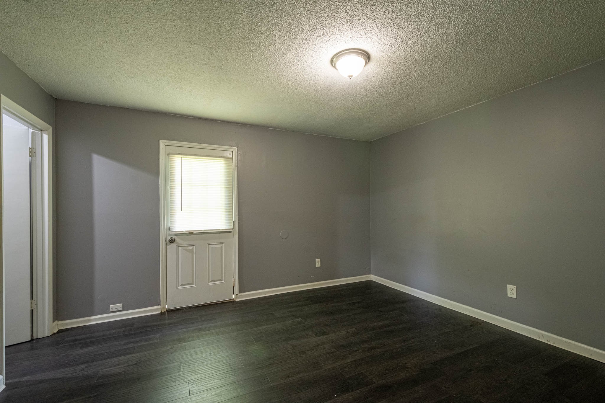 500 Bodenham Road Pulaski, TN 38478 - Photo 11 of 70 an empty room with wooden floor and windows