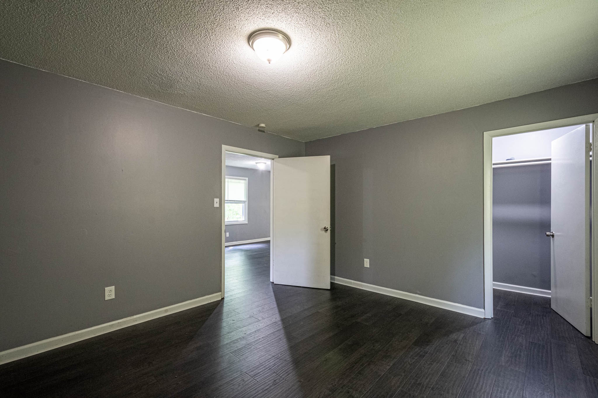 500 Bodenham Road Pulaski, TN 38478 - Photo 12 of 70 an empty room with wooden floor & windows and bathroom