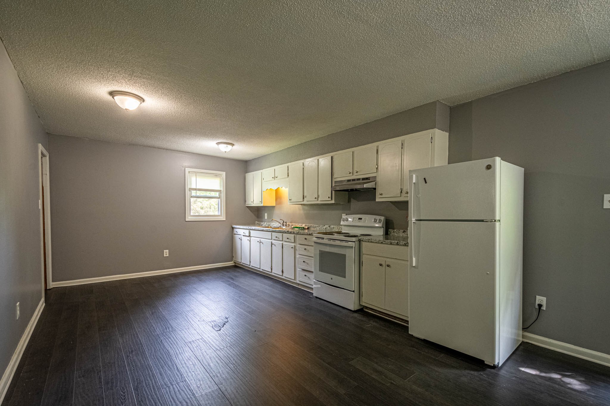 500 Bodenham Road Pulaski, TN 38478 - Photo 5 of 70 a kitchen with a refrigerator a stove top oven and wooden floor