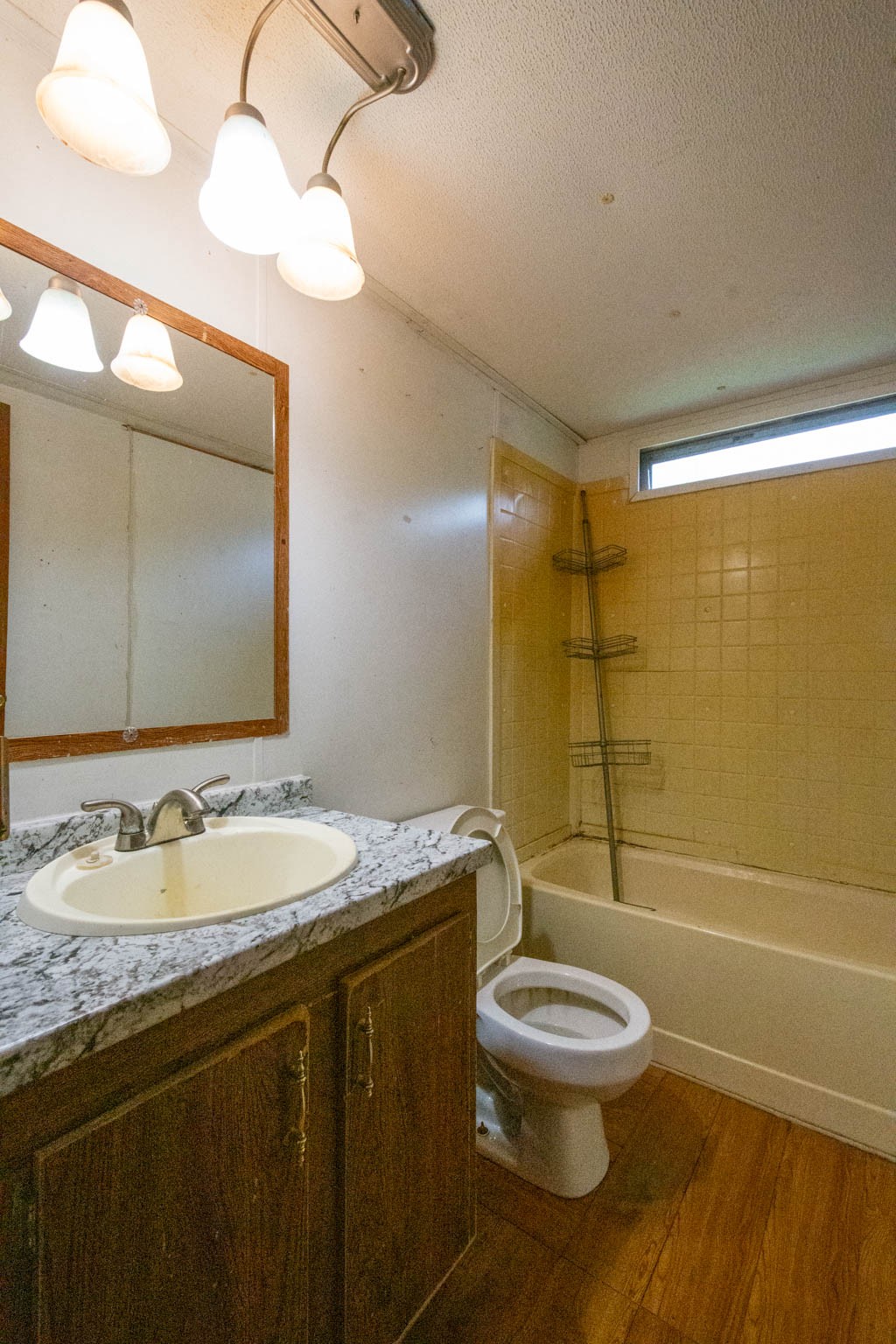 500 Bodenham Road Pulaski, TN 38478 - Photo 52 of 70 a bathroom with a granite countertop sink a toilet and shower