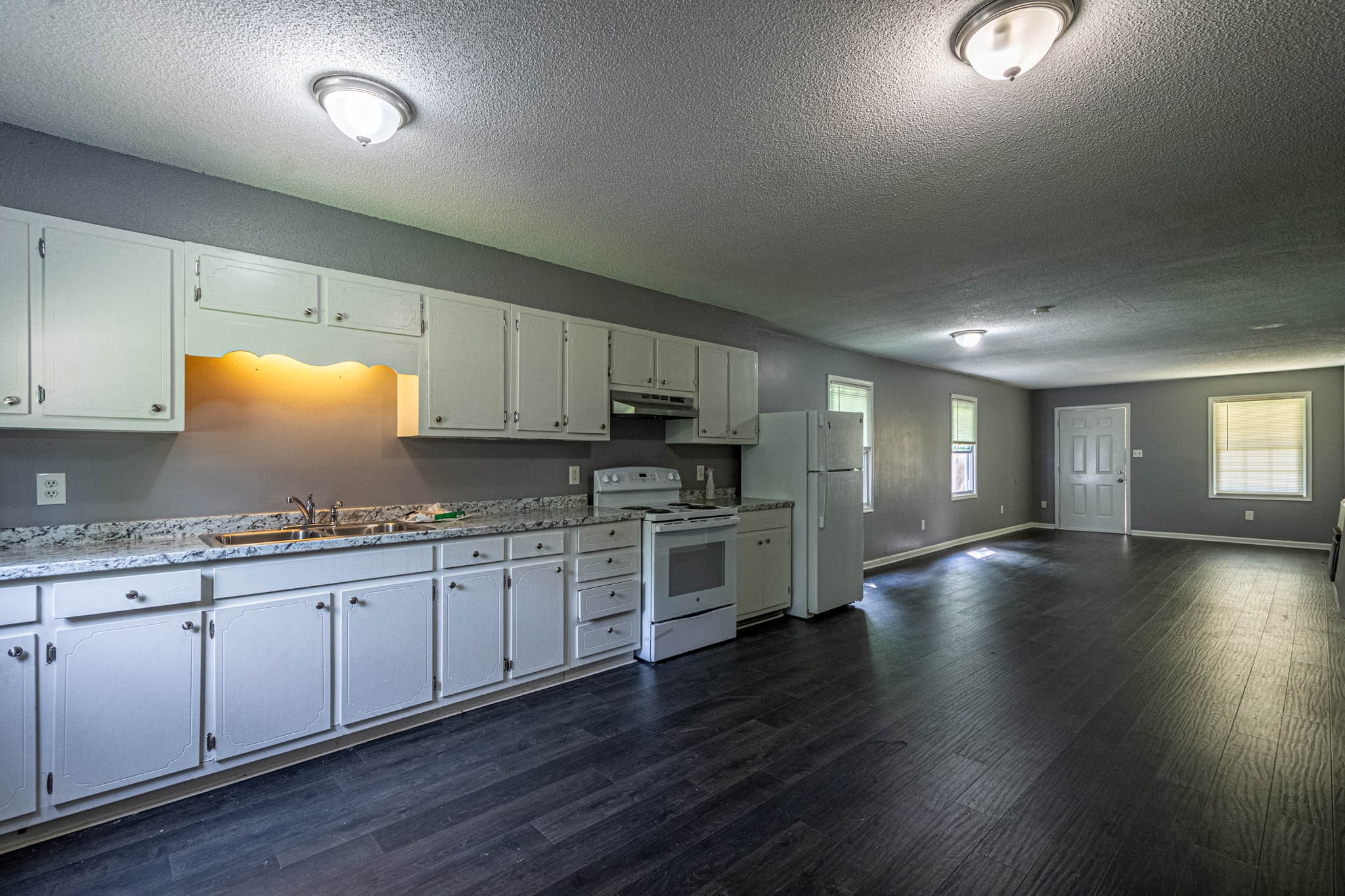 500 Bodenham Road Pulaski, TN 38478 - Photo 9 of 70 a kitchen with stainless steel appliances granite countertop a stove a sink dishwasher and a microwave oven with wooden floor