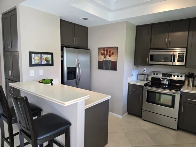 a kitchen with stainless steel appliances a stove microwave and refrigerator