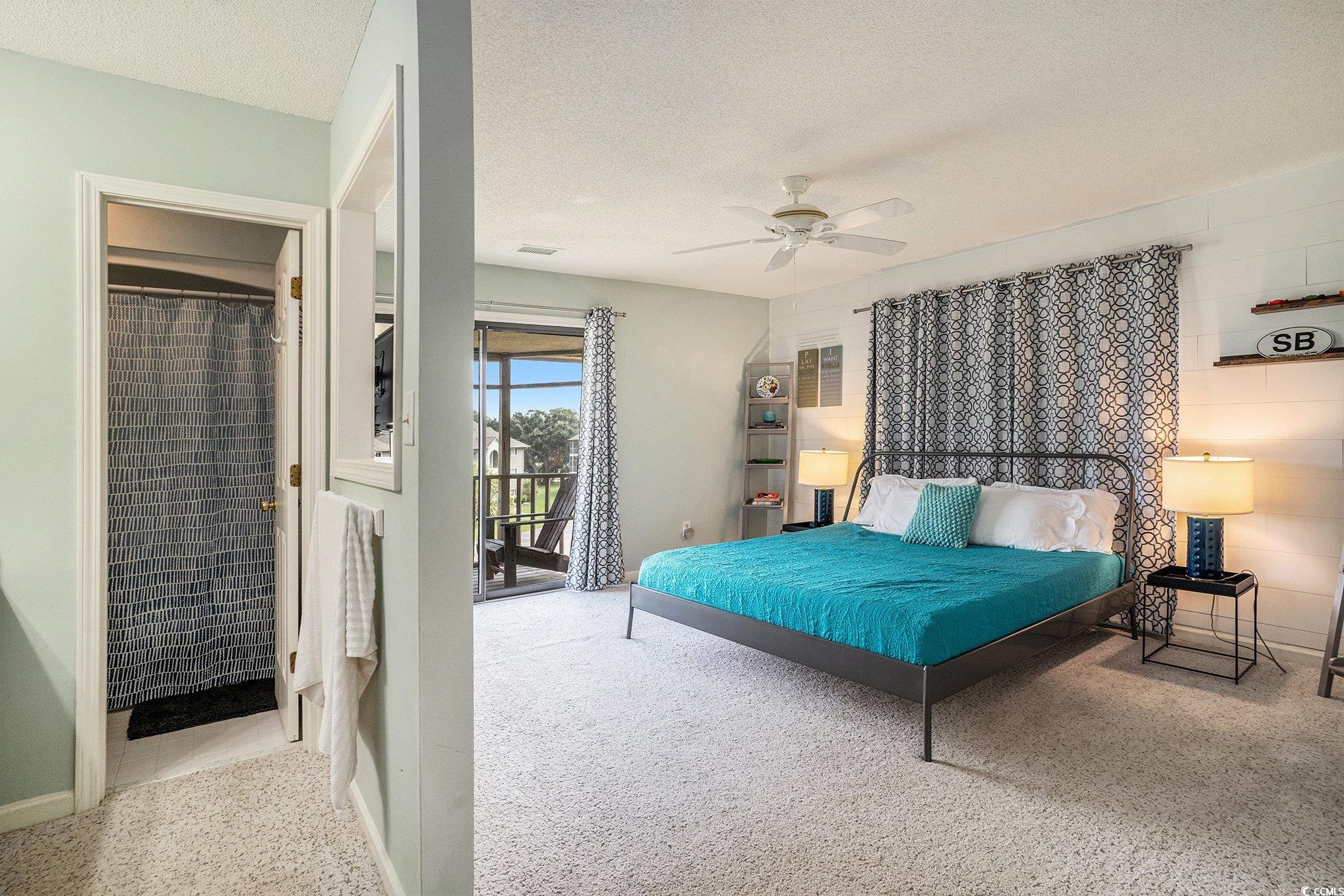 815 Colony Place, Unit 15F Sunset Beach, NC 28468 - Photo 12 of 34 Bedroom with light colored carpet, access to exterior, a textured ceiling, and a ceiling fan