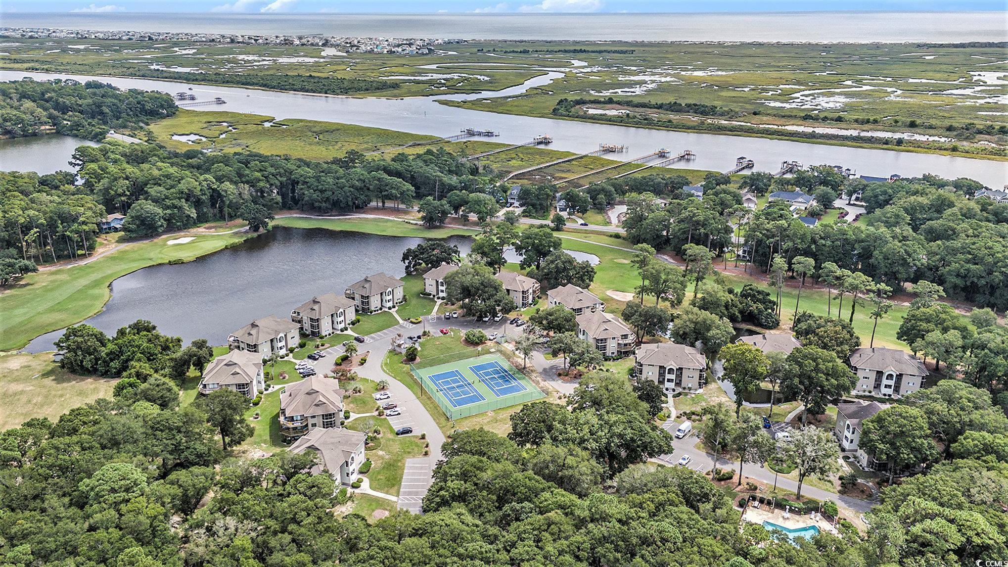 815 Colony Place, Unit 15F Sunset Beach, NC 28468 - Photo 25 of 34 Aerial view of residential area featuring a nearby body of water