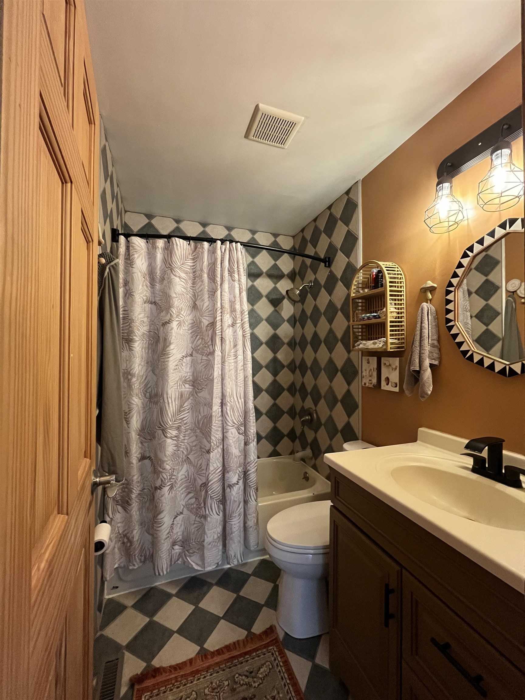 300 Lamplighter Loop Southeast Poplar Grove, IL 61065 - Photo 18 of 29 a bathroom with a sink a toilet a mirror and shower curtain