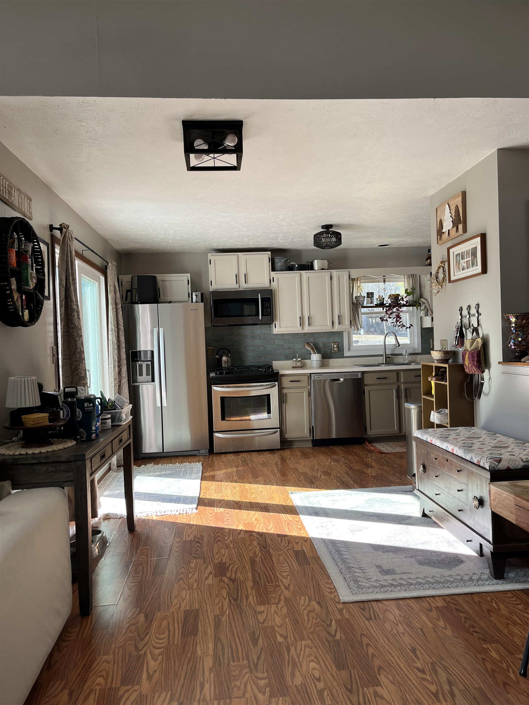 300 Lamplighter Loop Southeast Poplar Grove, IL 61065 - Photo 27 of 29 a kitchen with stainless steel appliances kitchen island granite countertop a stove top oven a sink a dining table and chairs with wooden floor