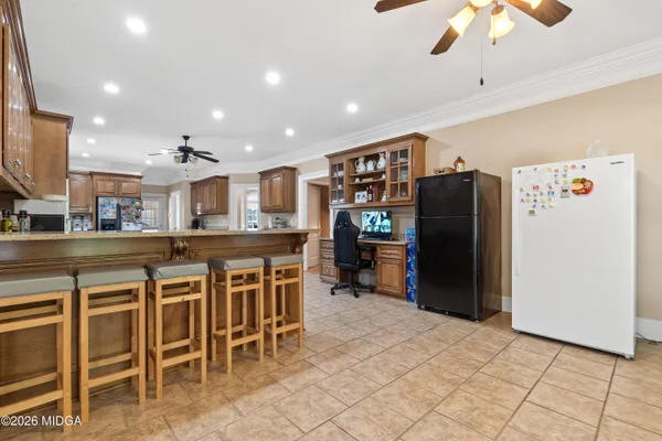 a room with furniture pool table wooden floor and windows