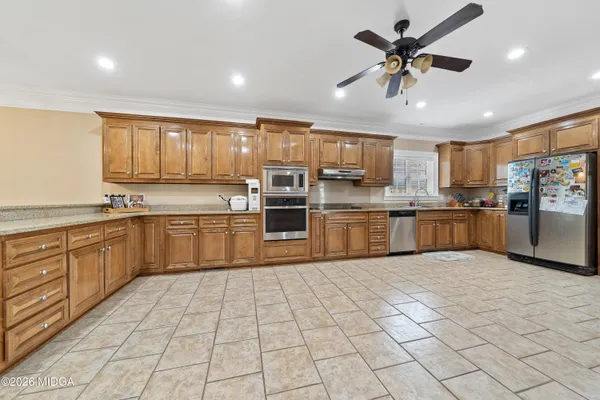 a bedroom with furniture and flat tv screen on the dresser