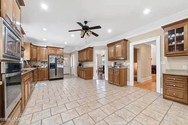 a bathroom with a granite countertop sink a toilet and shower