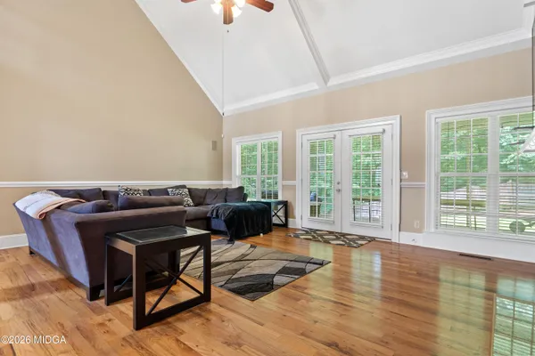 a living room with furniture a fireplace and a flat screen tv