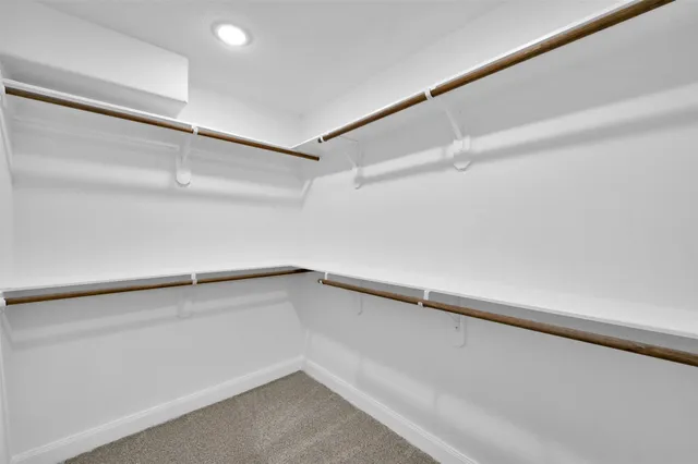 an empty room with windows and wooden floor