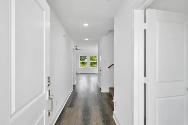 a view of a hallway with wooden floor
