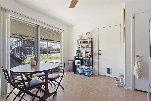 a dining room with furniture and a floor to ceiling window