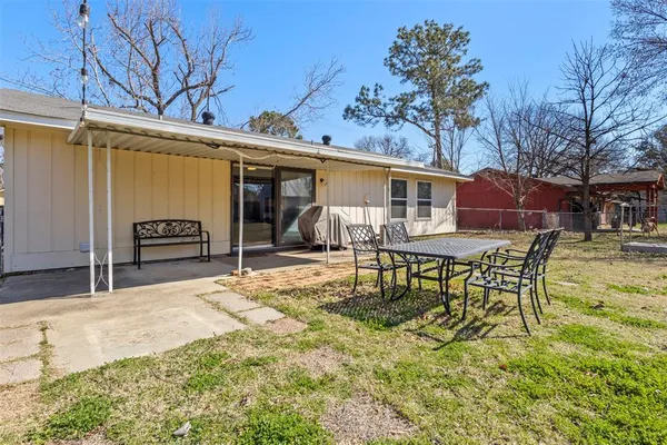 a backyard of a house with yard and outdoor seating