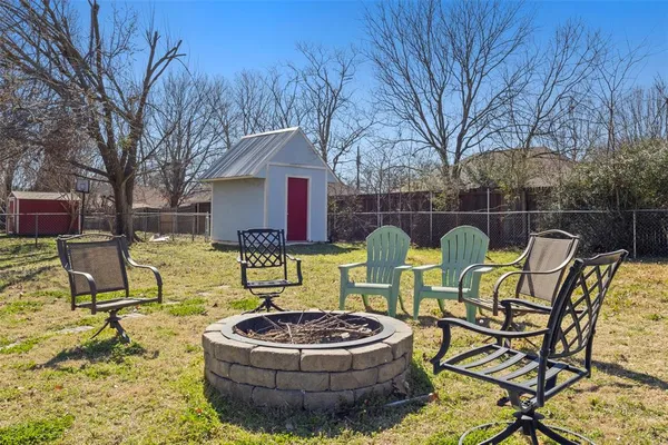 a backyard of a house with table and chairs