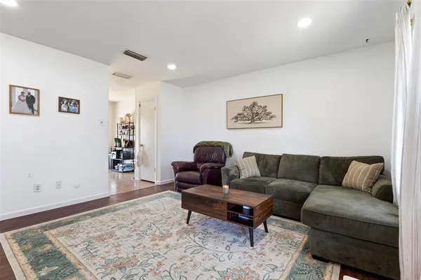 a living room with furniture and a rug