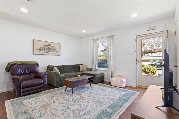 a living room with furniture and a rug