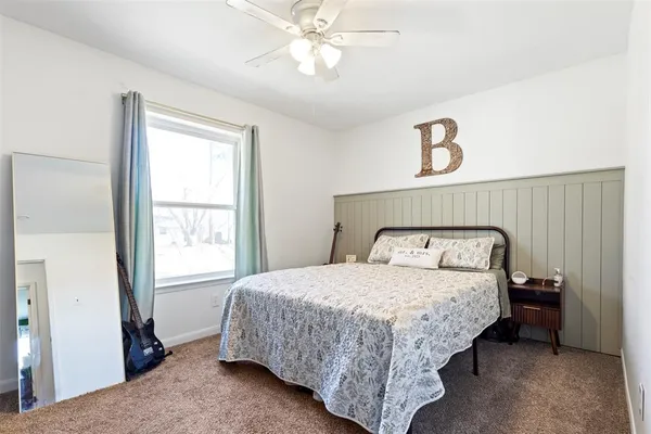 a bedroom with a bed and a window