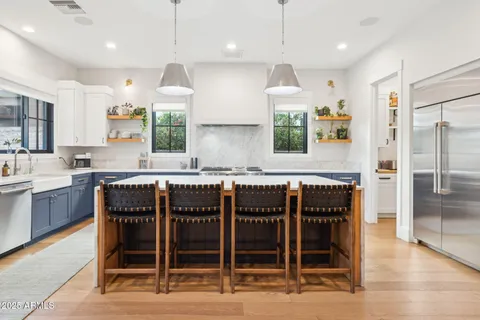 a large kitchen with a table and chairs