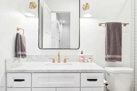 a bedroom with a bed and a potted plant