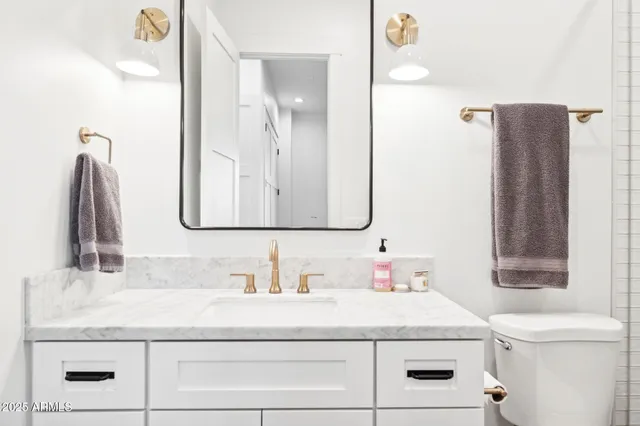 a bedroom with a bed and a potted plant