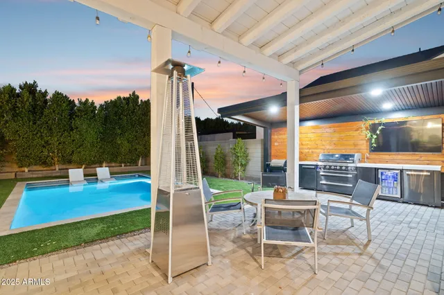 a view of a patio with table and chairs and potted plants