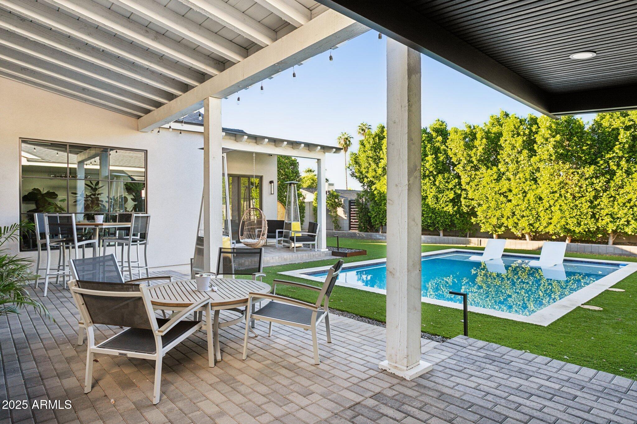 3530 East Glenrosa Avenue Phoenix, AZ 85018 - Photo 32 of 41 a view of a patio with table and chairs and potted plants