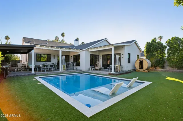 a view of an house with swimming pool and porch