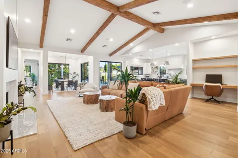 a living room with fireplace furniture and a large window