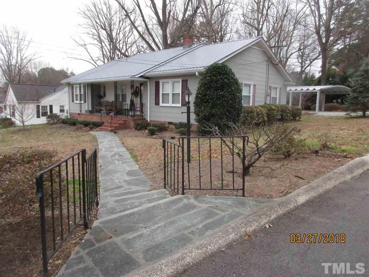511 Gordon Street Roxboro, NC 27573 - Photo 1 of 25 a view of a house with wooden fence next to a road