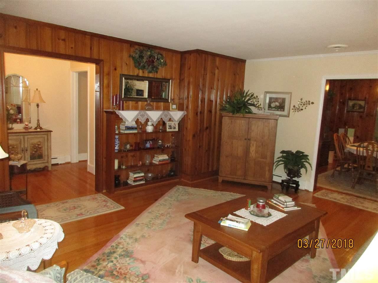 511 Gordon Street Roxboro, NC 27573 - Photo 12 of 25 a living room with furniture a rug and a flat screen tv