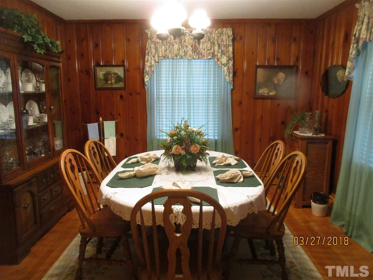 511 Gordon Street Roxboro, NC 27573 - Photo 13 of 25 a view of a dining room with furniture and chandelier