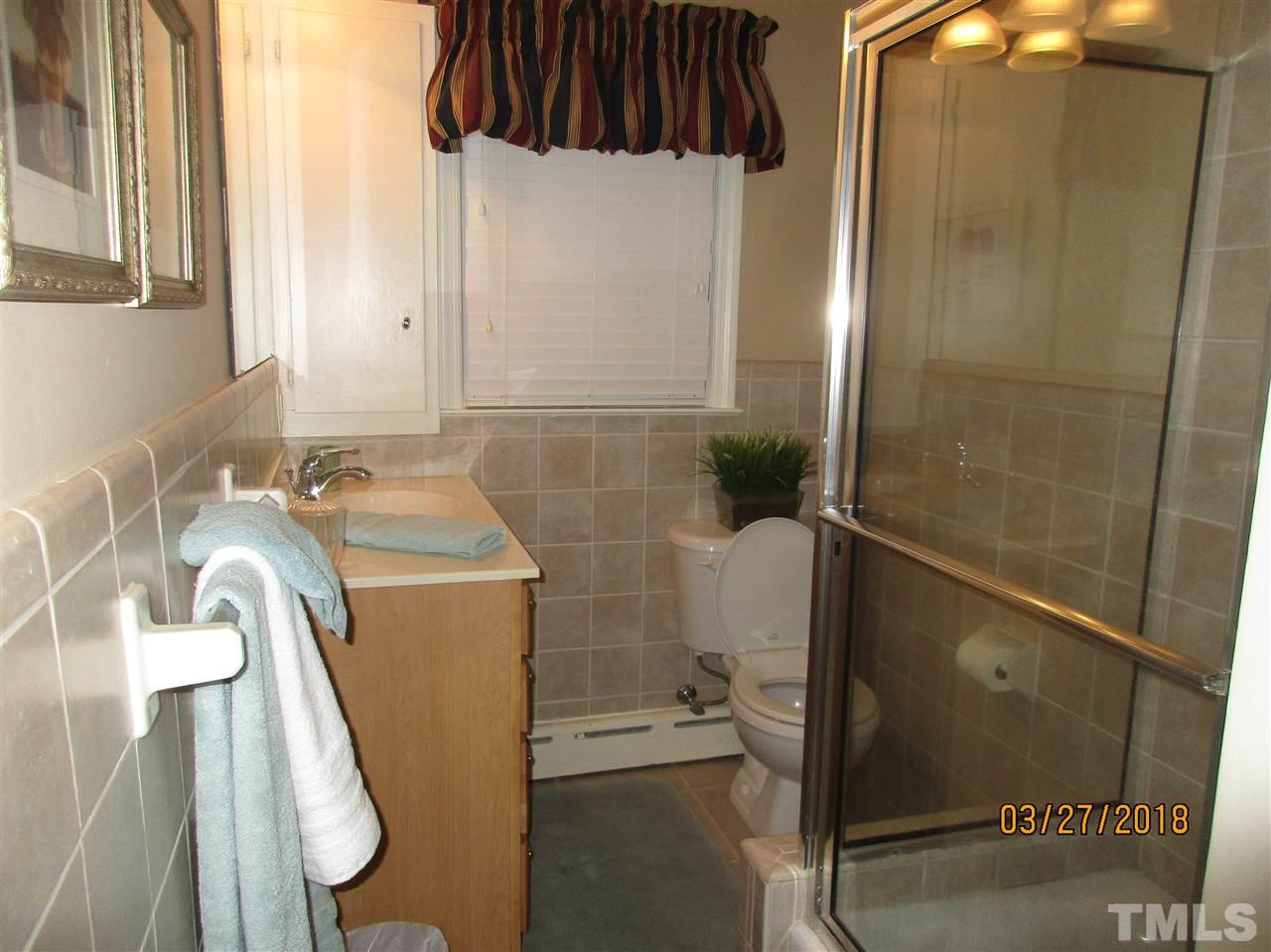 511 Gordon Street Roxboro, NC 27573 - Photo 16 of 25 a bathroom with a sink a toilet and shower