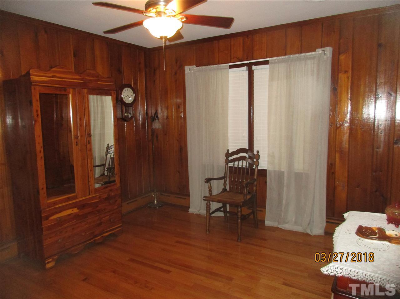 511 Gordon Street Roxboro, NC 27573 - Photo 18 of 25 a view of a hallway with wooden floor and furniture and a window