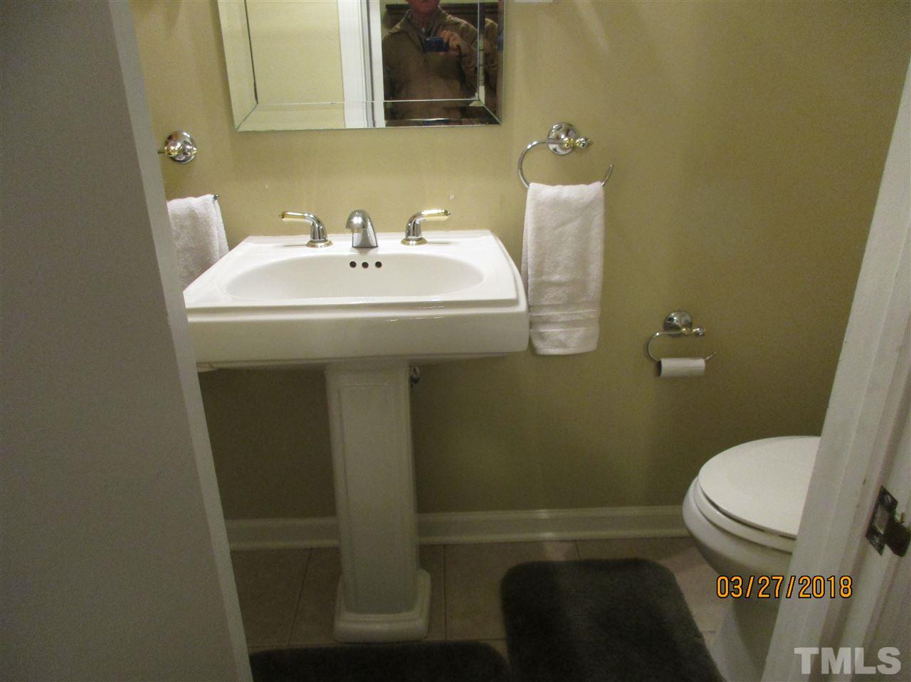 511 Gordon Street Roxboro, NC 27573 - Photo 19 of 25 a bathroom with a sink a toilet and a mirror