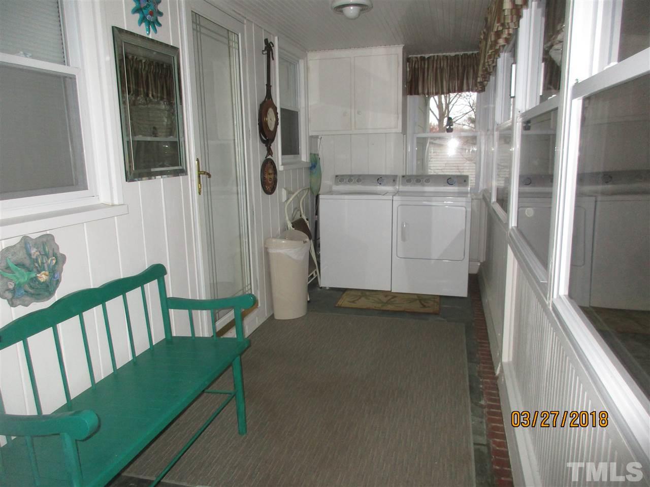 511 Gordon Street Roxboro, NC 27573 - Photo 23 of 25 a utility room with cabinets washer and dryer
