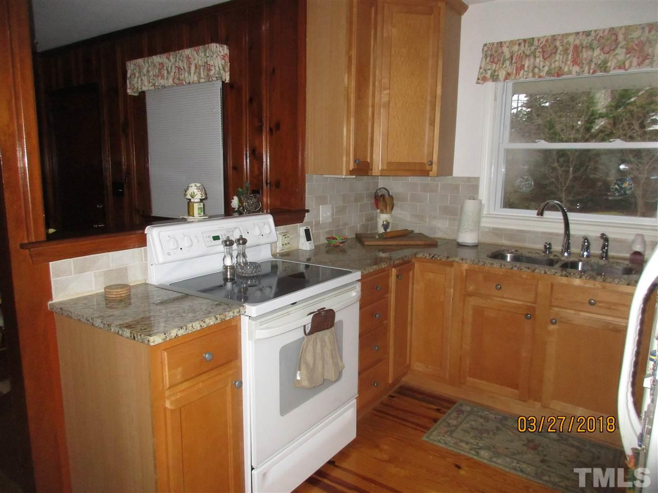 511 Gordon Street Roxboro, NC 27573 - Photo 6 of 25 a kitchen with stainless steel appliances granite countertop a sink stove and cabinets