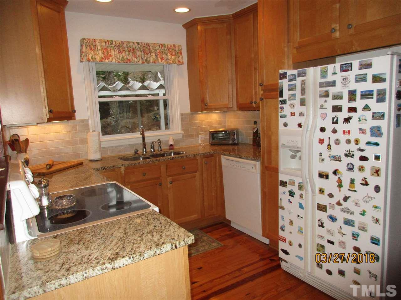 511 Gordon Street Roxboro, NC 27573 - Photo 7 of 25 a kitchen with granite countertop a sink and a stove top oven
