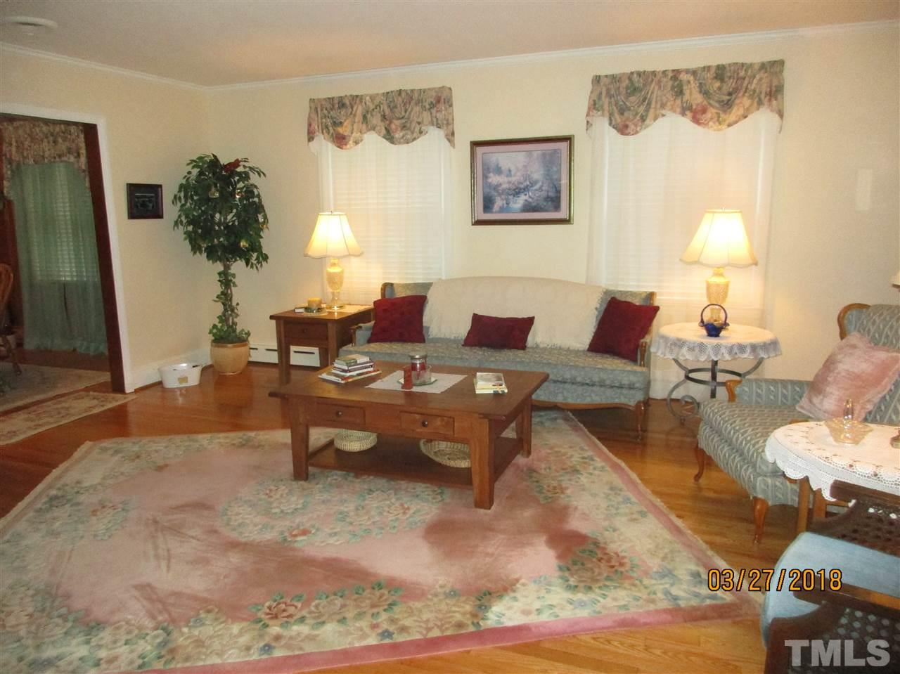 511 Gordon Street Roxboro, NC 27573 - Photo 10 of 25 a living room with furniture a lamp and a potted plant