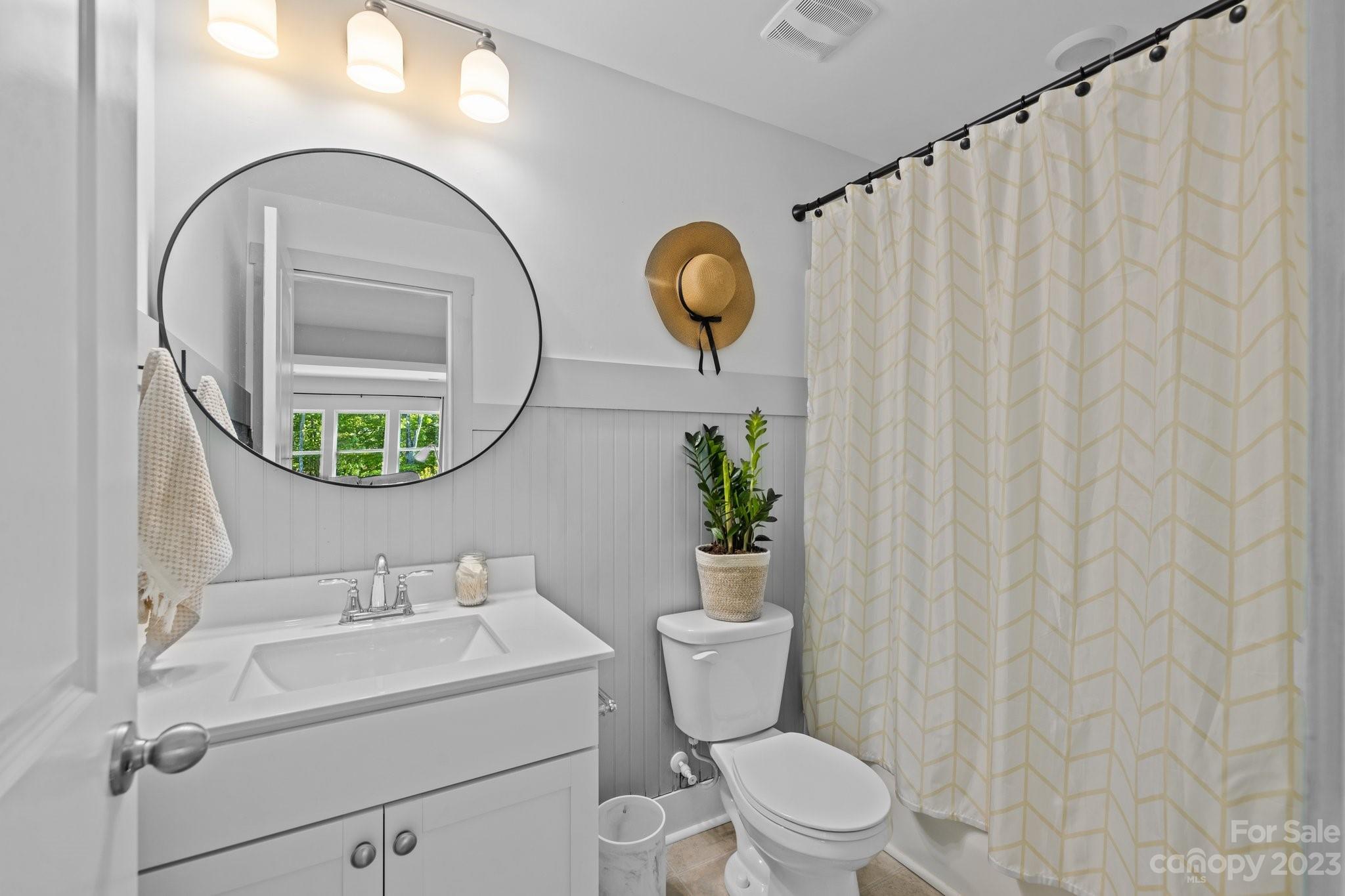 6284 Six String Court Fort Mill, SC 29708 - Photo 28 of 39 a bathroom with a sink a mirror a toilet and a window