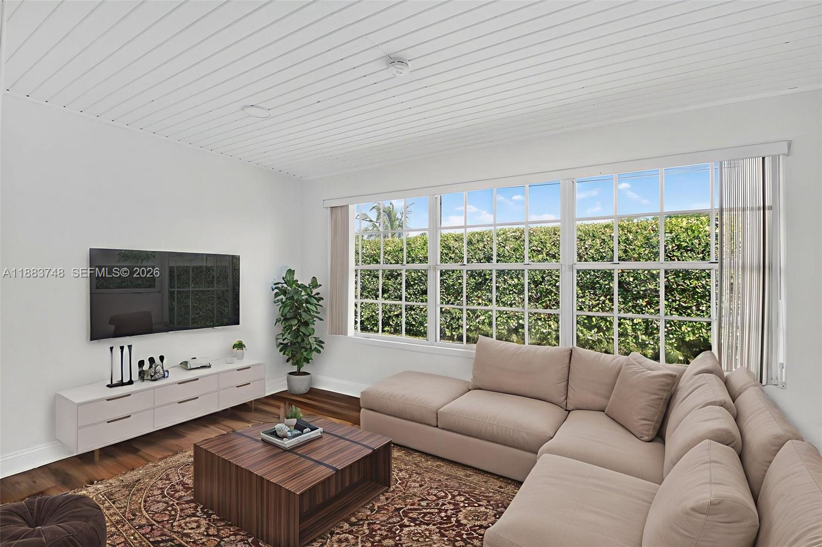 8371 Southwest 32nd Terrace Miami, FL 33155 - Photo 16 of 48 a living room with furniture a flat screen tv and a large window