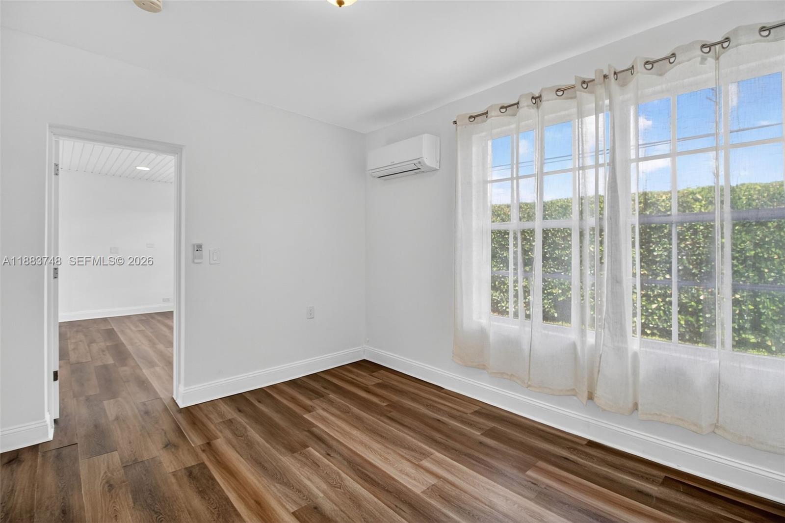 8371 Southwest 32nd Terrace Miami, FL 33155 - Photo 17 of 48 a view of empty room with wooden floor and fan