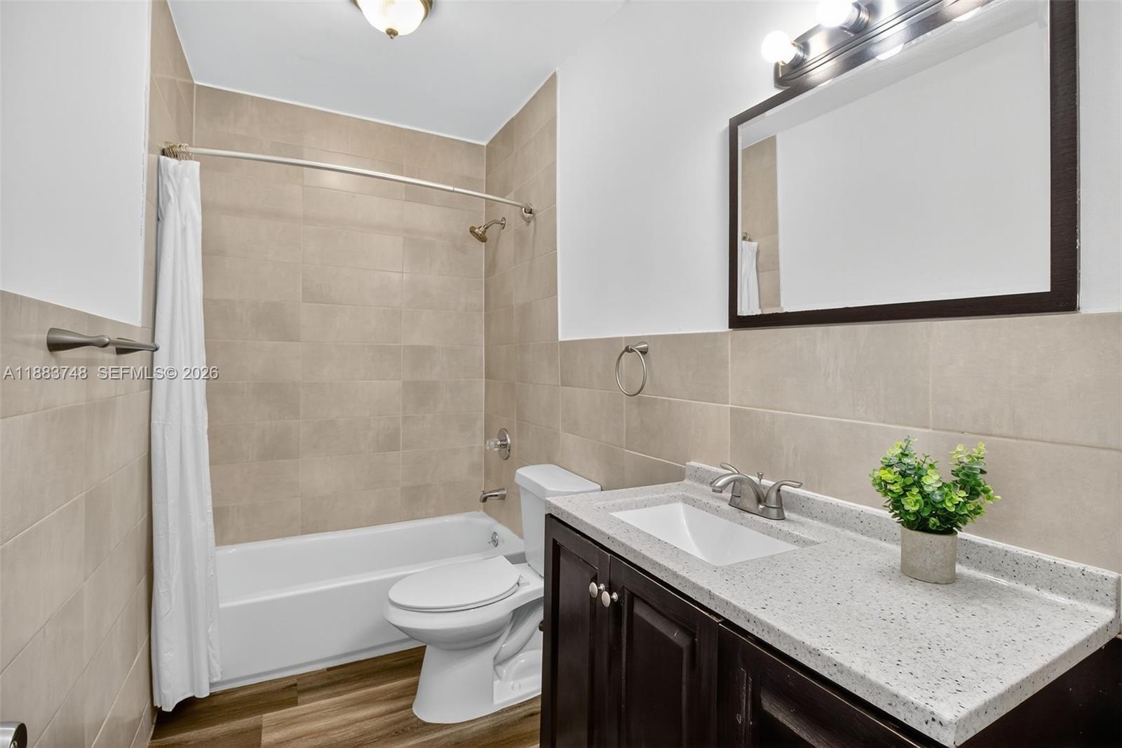 8371 Southwest 32nd Terrace Miami, FL 33155 - Photo 20 of 48 a bathroom with a granite countertop sink toilet and shower